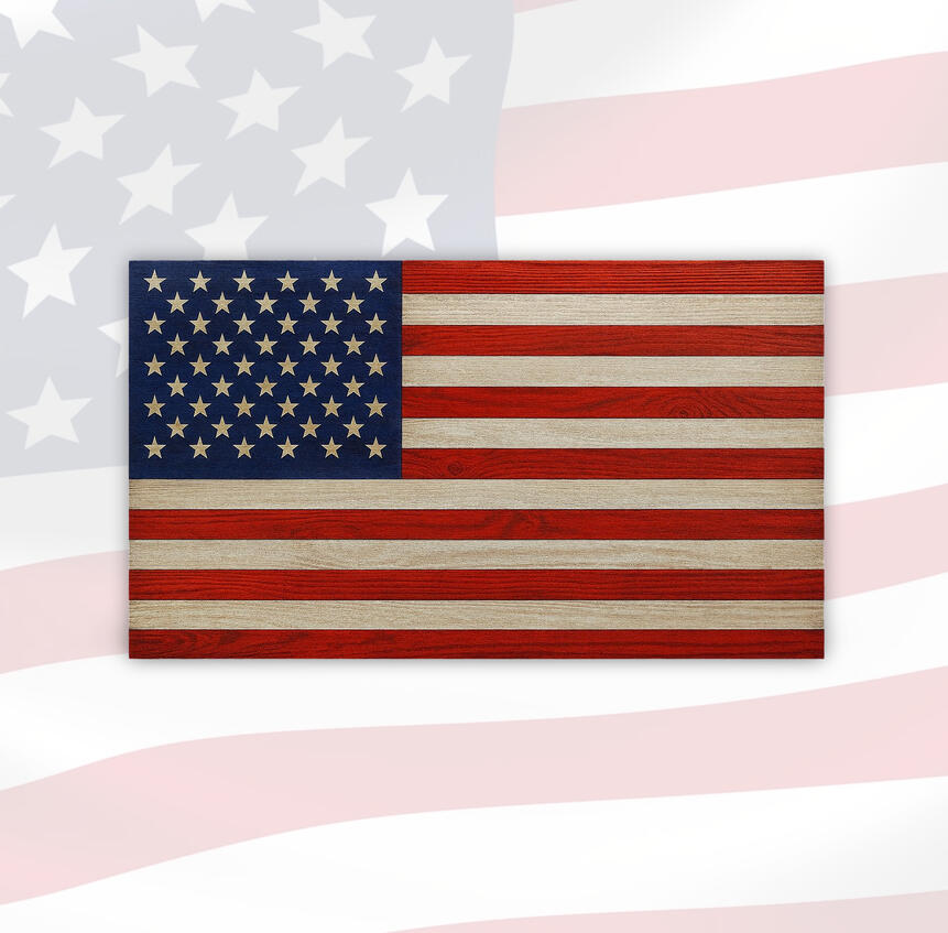 A handcrafted wooden American flag wall art with 50 carved stars on a navy blue field and rustic red and natural woodgrain stripes, displayed against a faded flag background.
